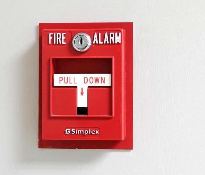 white wall with red fire alarm
